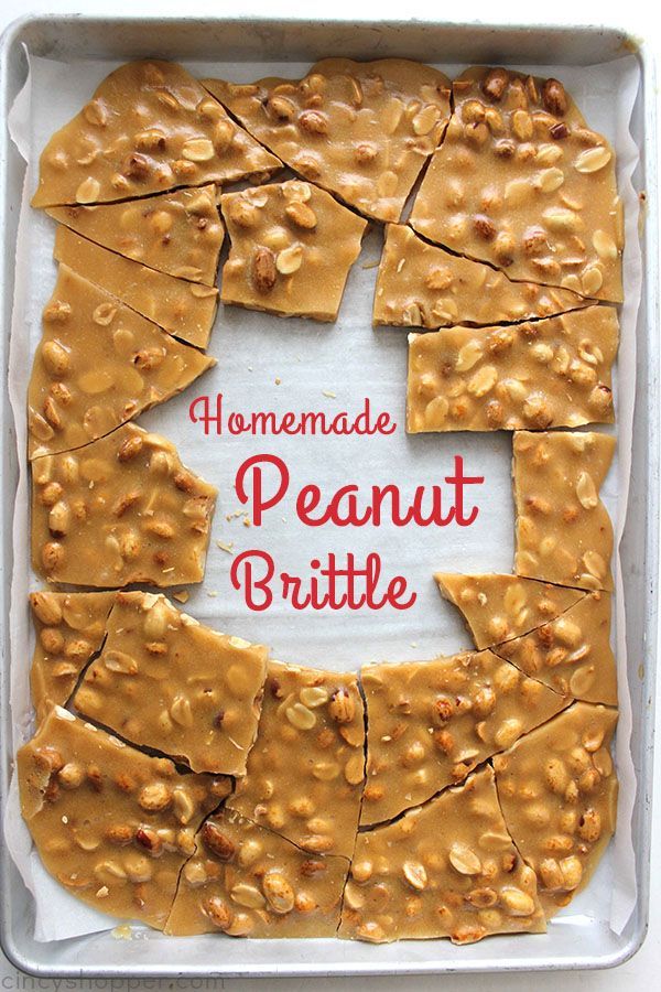 homemade peanut brittle is cut into squares and placed in a pan