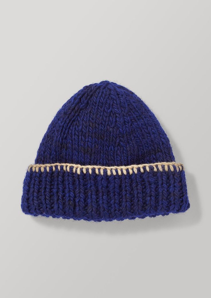 a blue knitted hat with gold trim