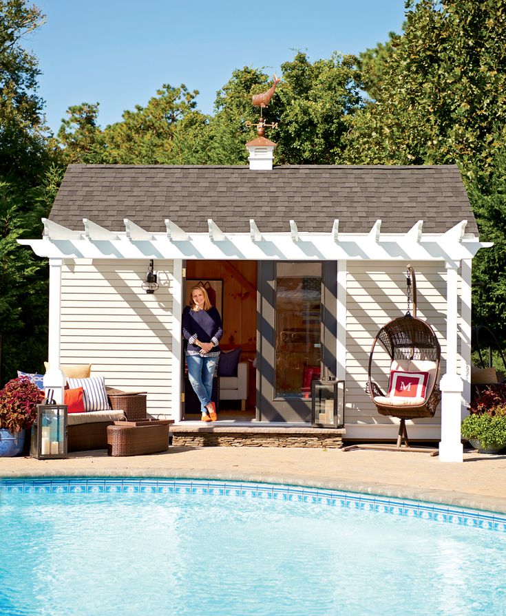 a woman standing in the doorway of a pool house