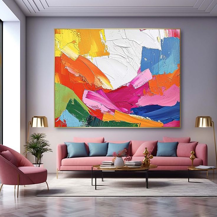 an abstract painting hangs on the wall above a pink couch and chair in a modern living room