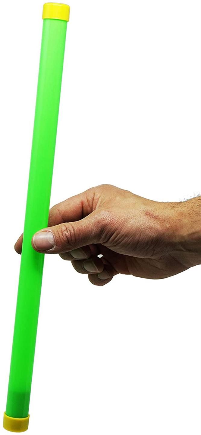 a hand holding a green tube with yellow tips