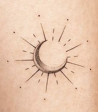 a small sun and moon tattoo on the stomach