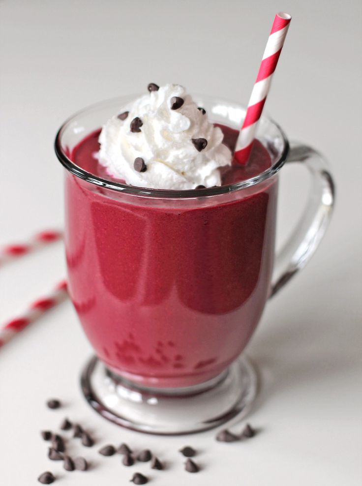 a red drink with whipped cream and chocolate chips