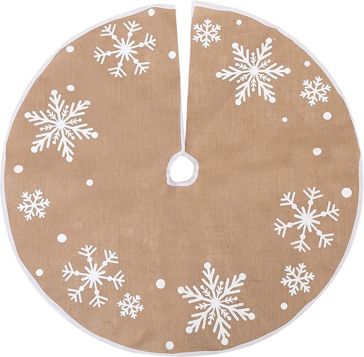 a round christmas tree skirt with white snowflakes on the front and bottom, hanging from a string