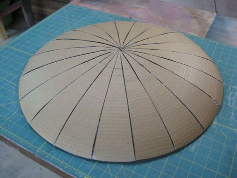 a large wooden object sitting on top of a blue cutting mat with lines drawn across it