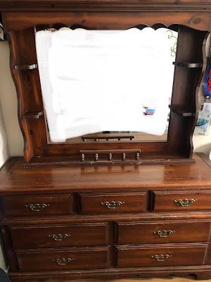 an old dresser with a mirror on top