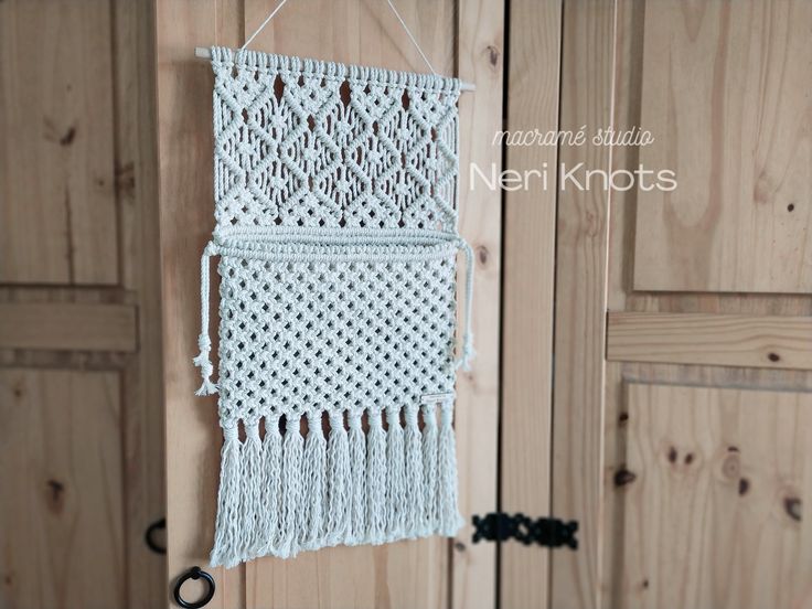 a crocheted wall hanging on a wooden door