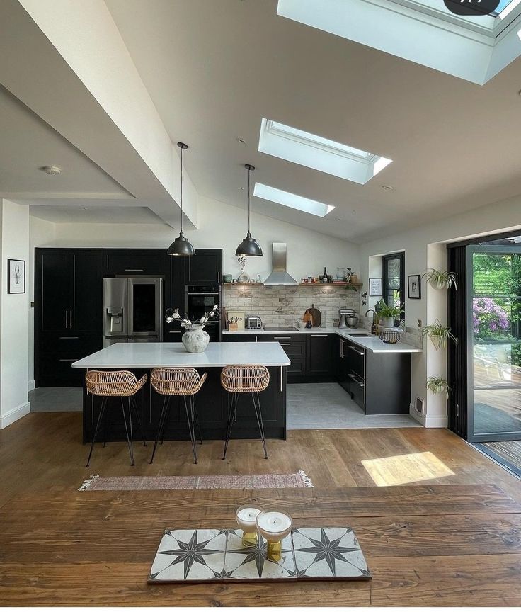 an open kitchen and dining room with skylights