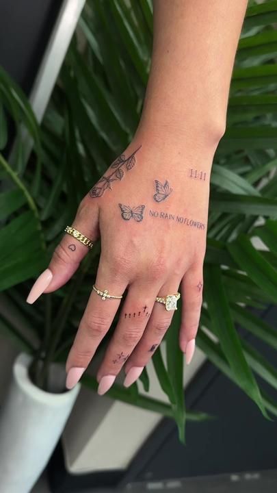 a woman's hand with tattoos on it