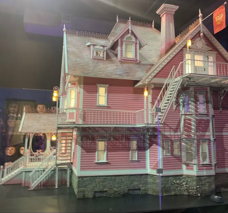 a pink doll house on display in a store window