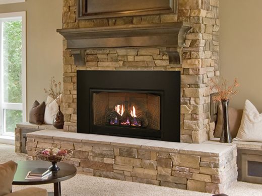 a living room filled with furniture and a fire place in the middle of a fireplace