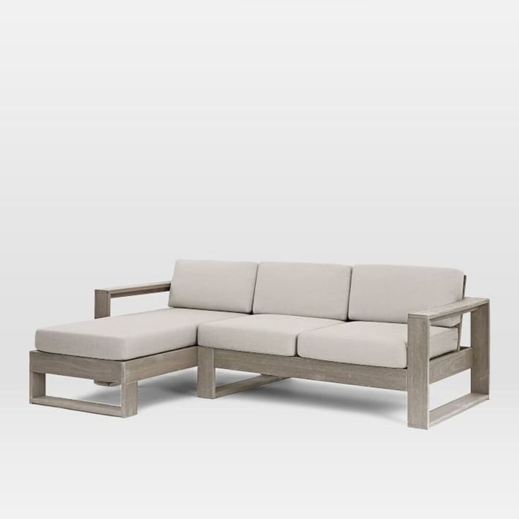 a white couch sitting on top of a wooden frame