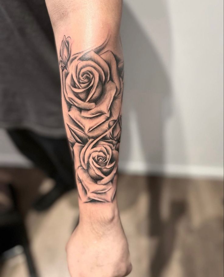 a person with a rose tattoo on their arm and leg is standing in front of the camera