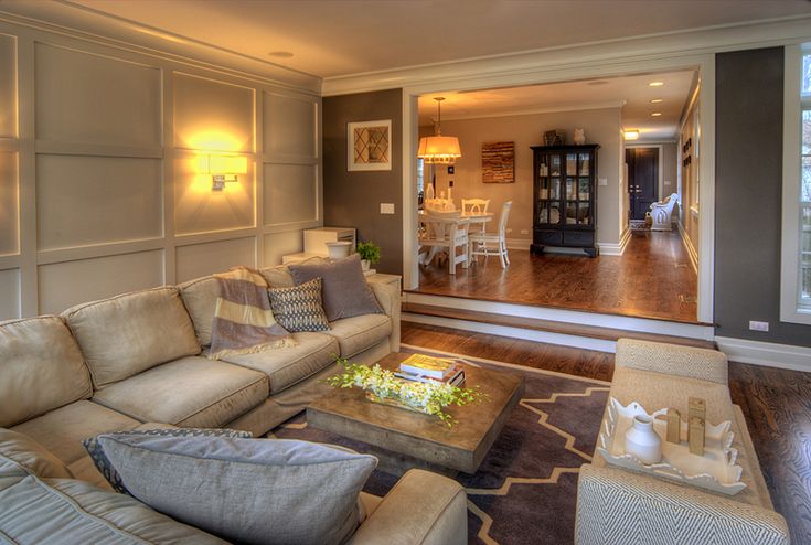 a living room filled with furniture and a fire place next to a large glass door