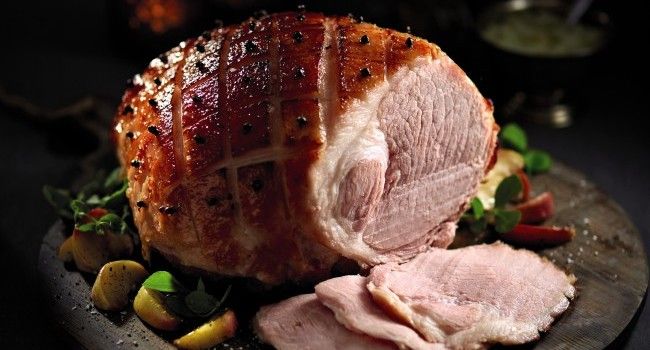 a large piece of meat sitting on top of a wooden plate