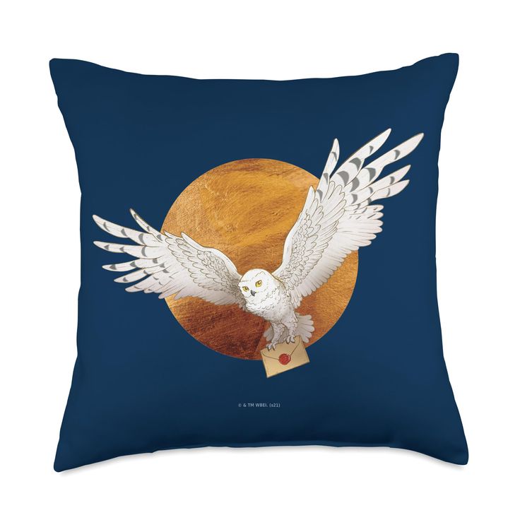 a pillow with an owl flying in front of a full moon on a blue background