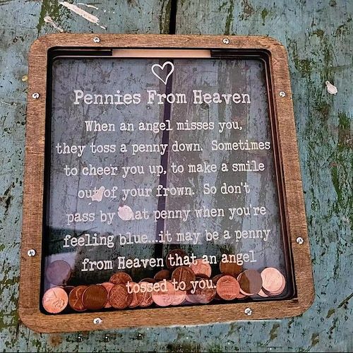 a wooden frame with some coins in it and a poem written on the front saying pennies from heaven