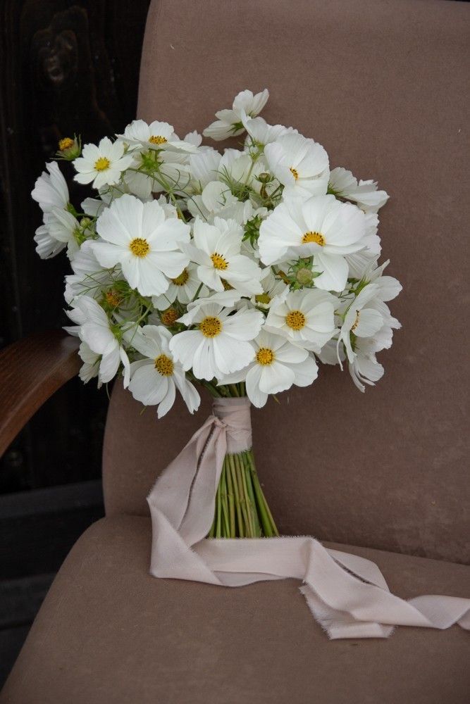 a bouquet of white flowers sitting on top of a chair