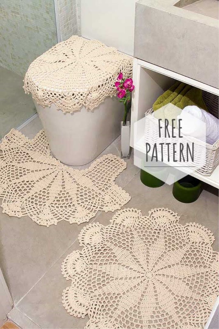 two crocheted doily rugs sitting on the floor next to a toilet