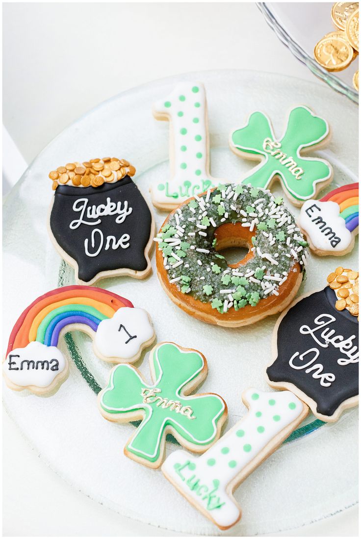 decorated cookies on a plate with shamrocks, rainbow and lucky one written on them