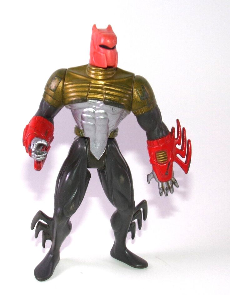 the action figure is posed with his hands on his hips and holding a metal object in one hand