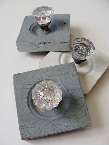 two pieces of metal sitting on top of a white table next to another piece of glass