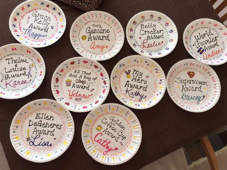 nine paper plates with words on them sitting on top of a table next to a purse