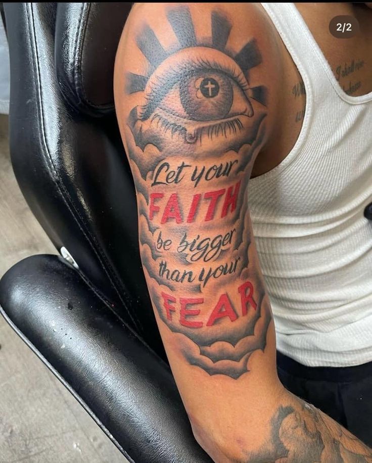 a man with a tattoo on his arm that says, let your faith be bigger than you fear