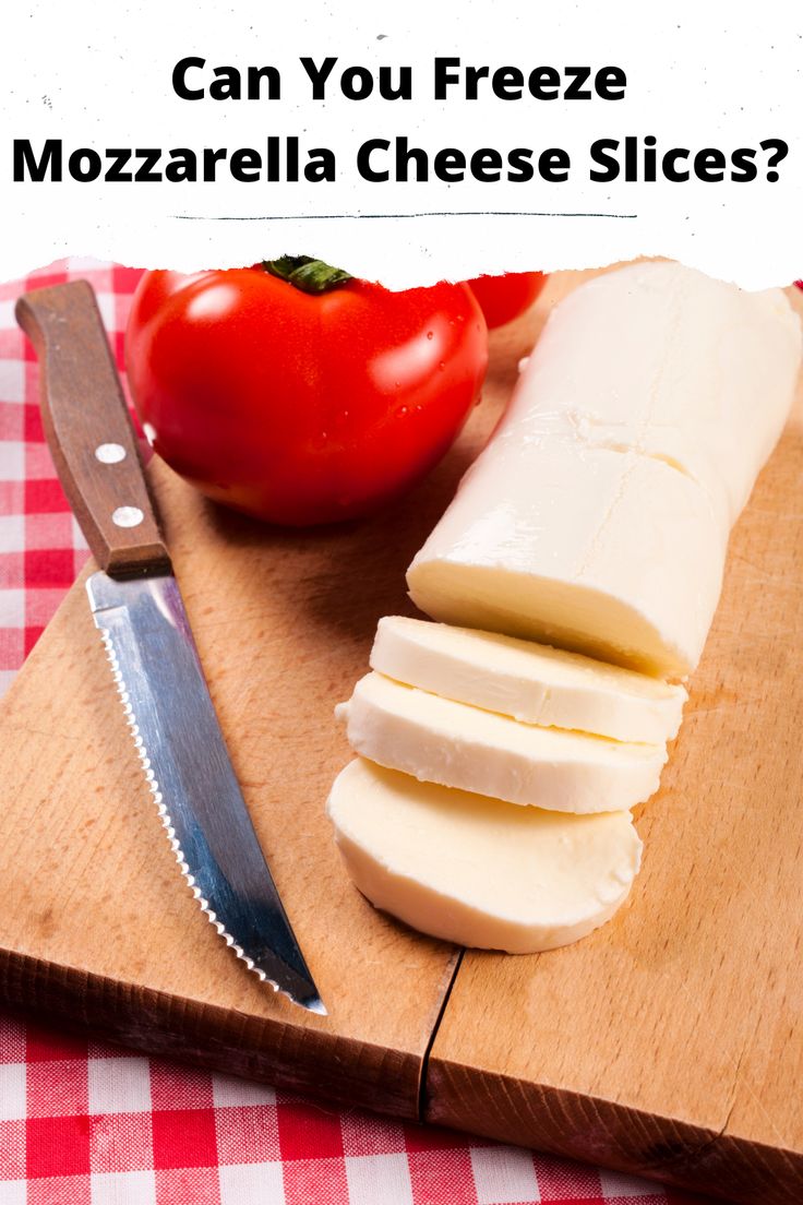 cheese slices on a cutting board with a knife and tomato in the background text reads can you freeze mozzarella cheese slices?