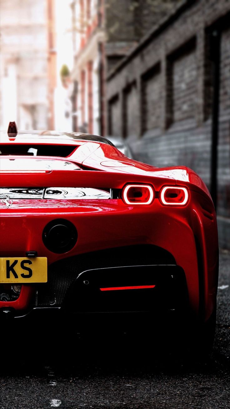 a red sports car is parked on the street