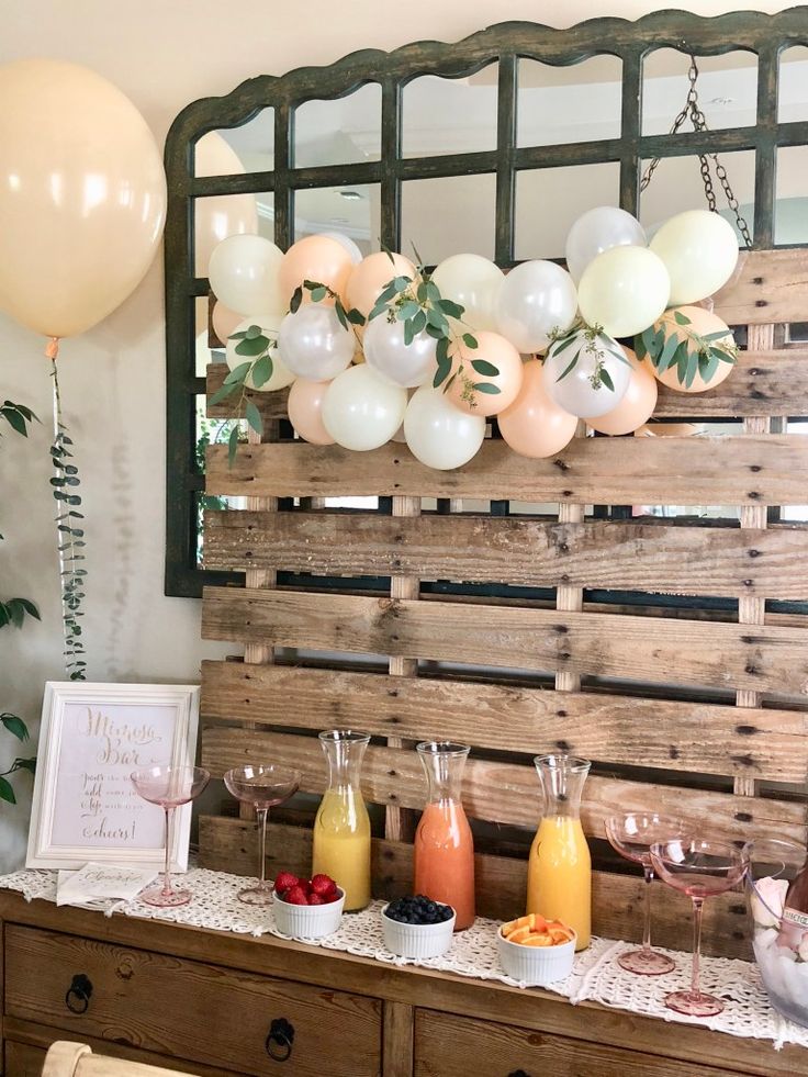 a buffet table with balloons and drinks on it