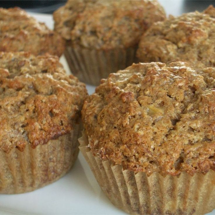 several muffins sitting on a white plate next to each other