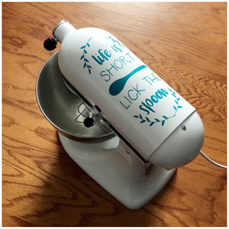 a close up of a blender on a wooden table with writing on the side