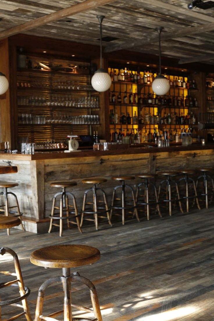 an empty bar with several stools in front of it