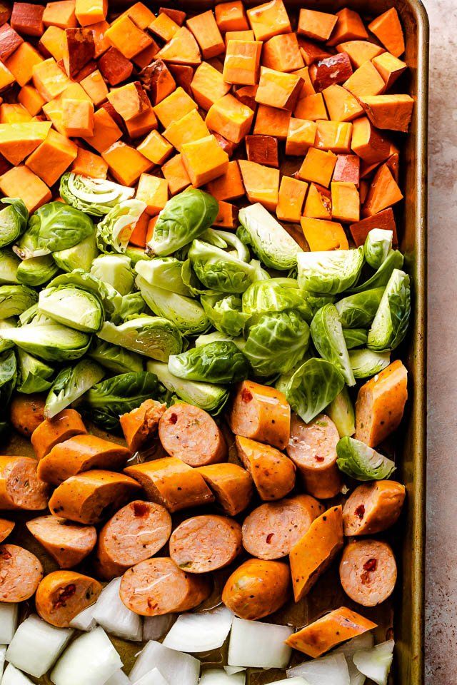 an assortment of vegetables and meats in a baking dish