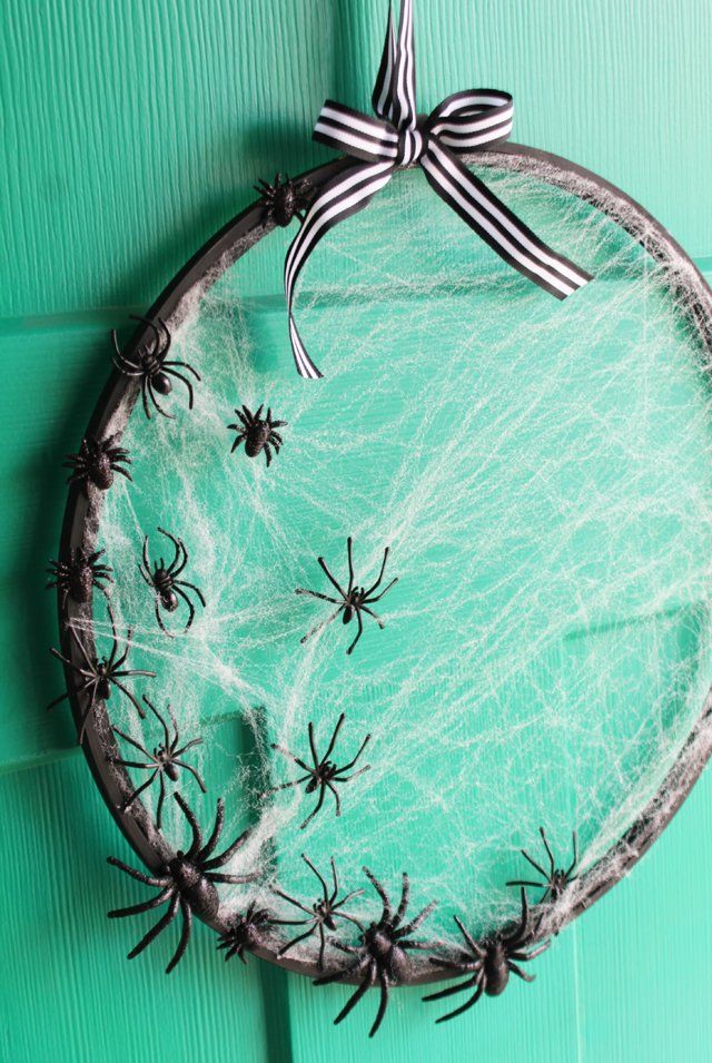 a glass plate with spider webs on it and a bow hanging from the top