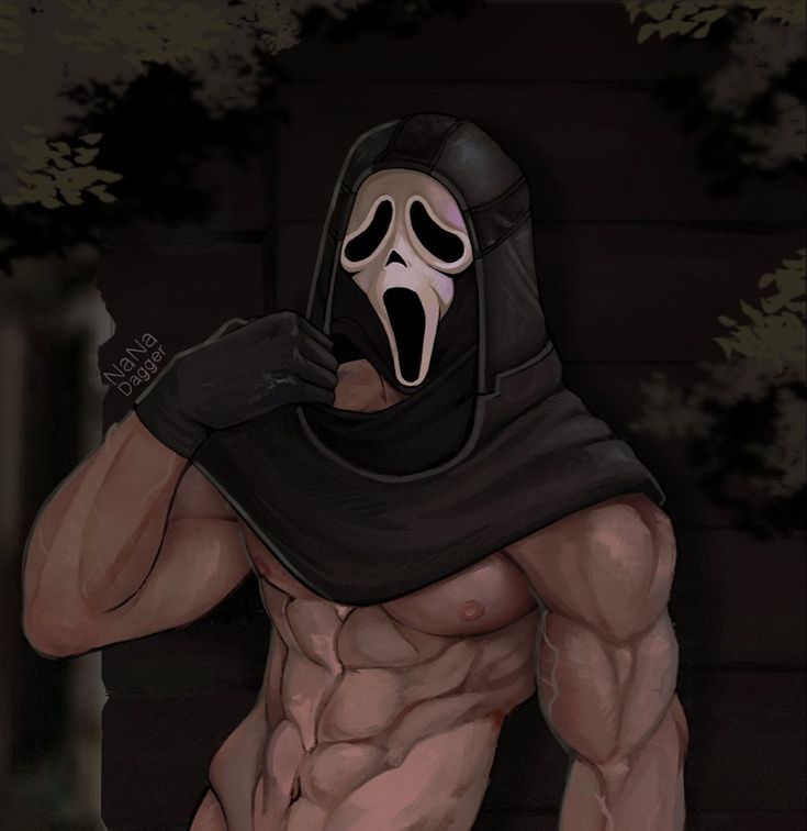 a man with a mask on his face and wearing a hood is posing for the camera