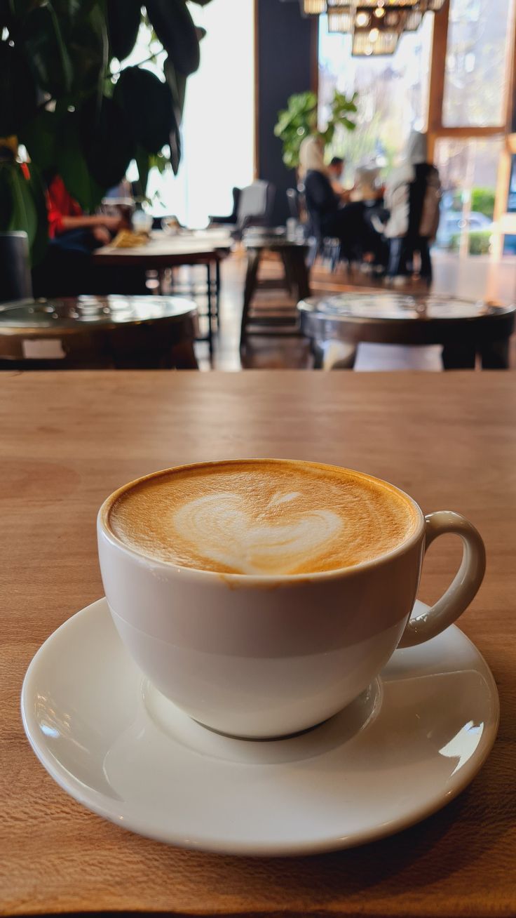 a cappuccino is sitting on a saucer