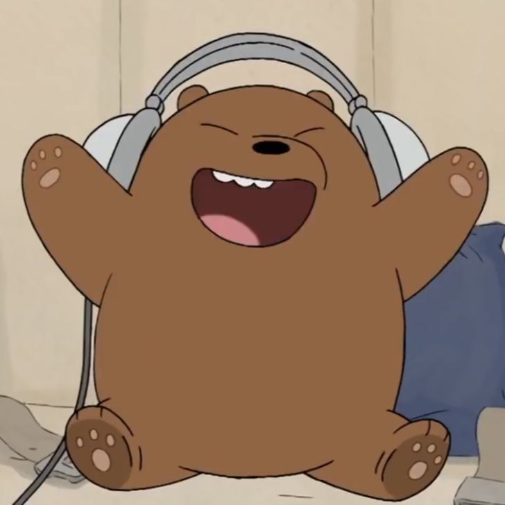 a brown bear with headphones sitting on top of it's back and mouth open