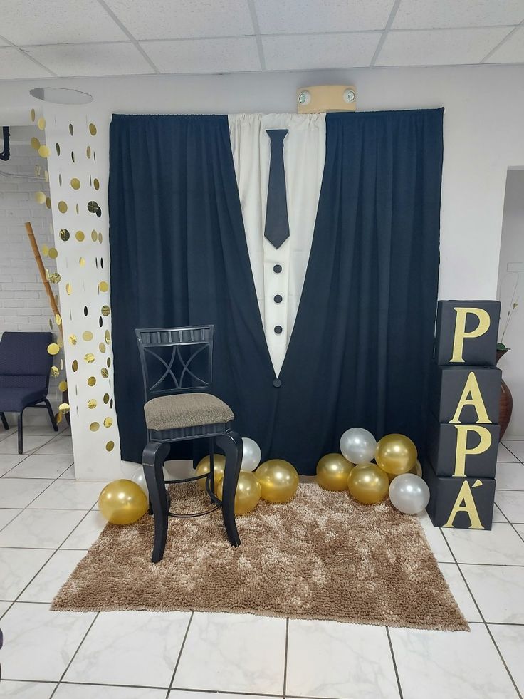 a room decorated with balloons, chairs and a chair in front of a backdrop that says papa