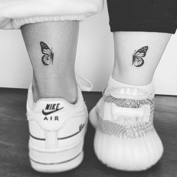 two small tattoos on the legs of people's feet, one with a butterfly