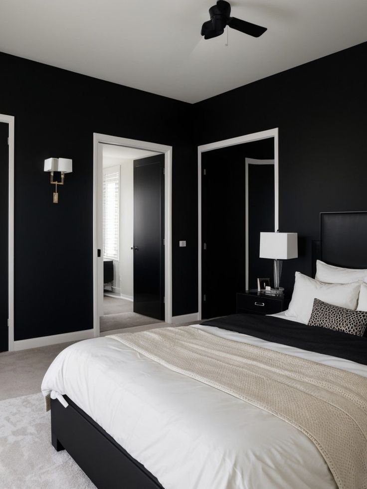 a bedroom with black walls and white bedding