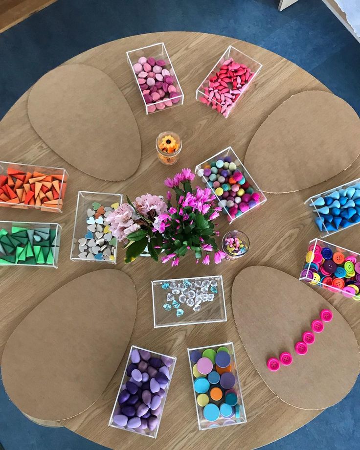 the table is covered with crafting supplies and flowers