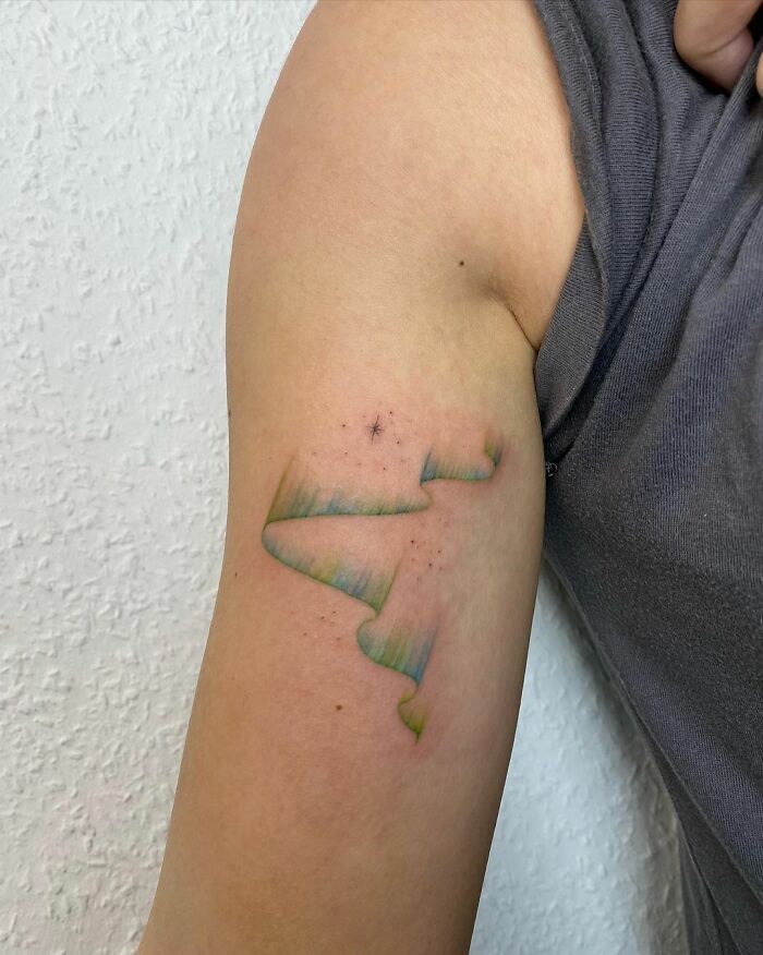 a person with a tattoo on their arm