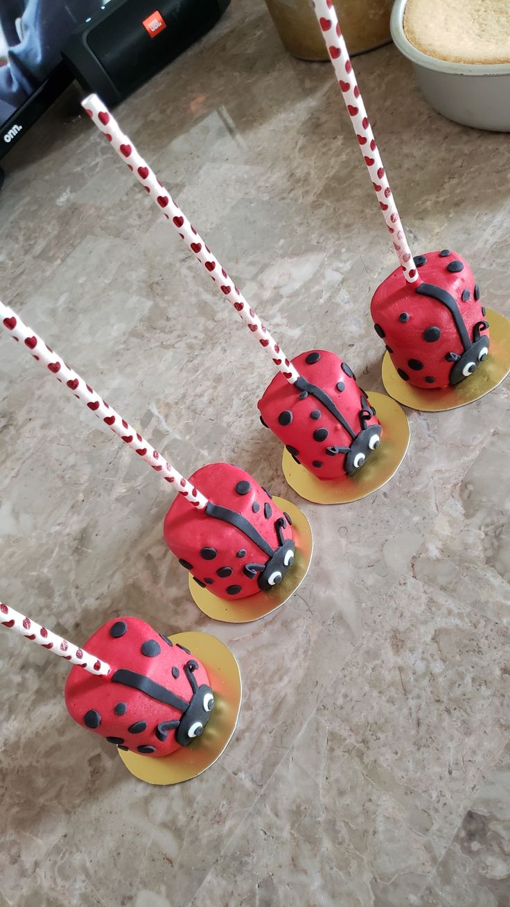 three ladybug cake pops sitting on top of each other