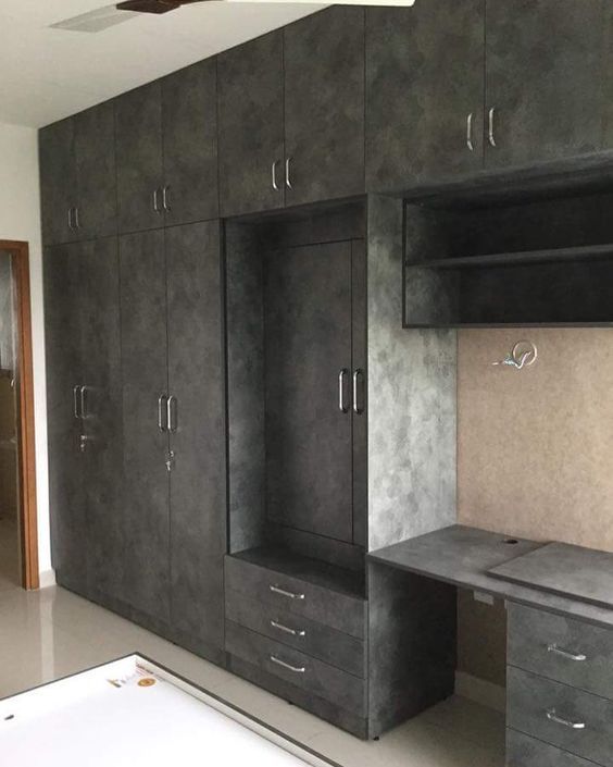 an empty room with black cabinets and drawers