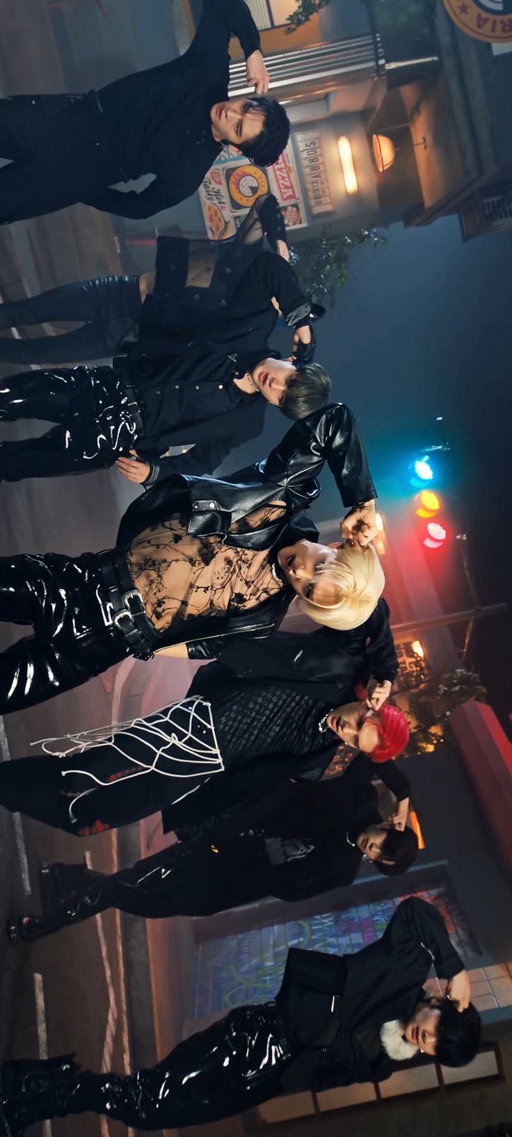 group of people dressed in latex posing for the camera with their hands on their hipss