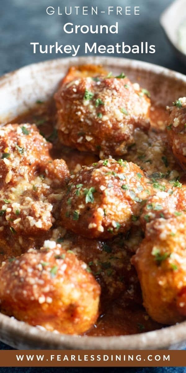 some meatballs are in a white bowl