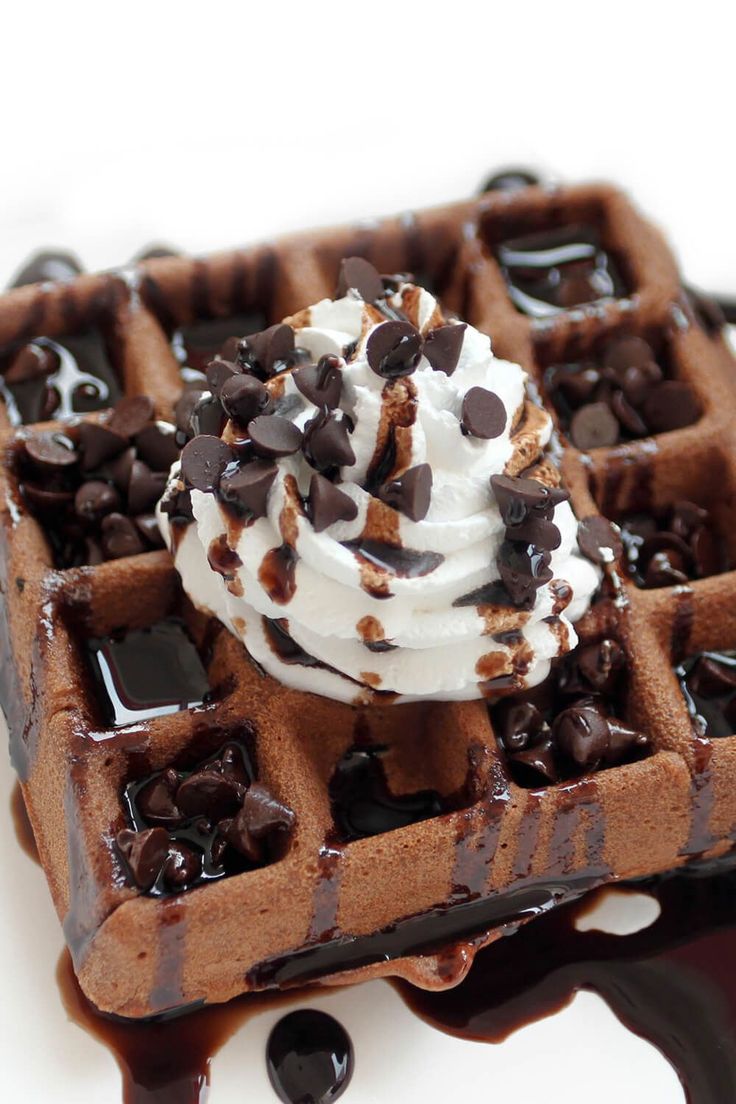 a waffle topped with whipped cream and chocolate chips