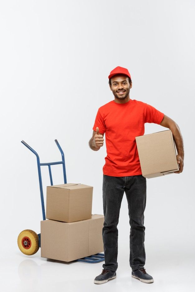 a man holding two boxes and giving the thumbs up while standing in front of cardboard boxes